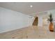 Open concept living space featuring tile floors, stairs to the upper level, and access to other rooms at 7619 Belgian Lion St, Las Vegas, NV 89139