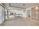 Open floor plan of living room with tile floors throughout the space and into the kitchen at 7619 Belgian Lion St, Las Vegas, NV 89139