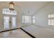 Bright living room featuring plantation shutters, a high ceiling, and tile and carpet flooring at 7619 Belgian Lion St, Las Vegas, NV 89139