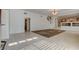 Open living room featuring tile floors, neutral walls, and staircase access at 7619 Belgian Lion St, Las Vegas, NV 89139
