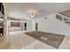 Spacious living room with tile flooring, chandelier, and adjacent bar area at 7619 Belgian Lion St, Las Vegas, NV 89139