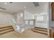 Bright loft area with neutral carpet, glass railings, and views into the adjacent living room at 7619 Belgian Lion St, Las Vegas, NV 89139