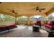 Large covered patio with outdoor seating and ceiling fans at 7619 Belgian Lion St, Las Vegas, NV 89139