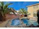 Hot tub and beautiful private pool with rock waterfall, and tropical landscaping at 7619 Belgian Lion St, Las Vegas, NV 89139