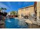 A private pool with rock waterfall, seating area, and tropical landscaping offers a relaxing retreat at 7619 Belgian Lion St, Las Vegas, NV 89139
