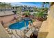 A stunning pool with a waterfall feature, spa, and a built-in BBQ area for outdoor entertaining at 7619 Belgian Lion St, Las Vegas, NV 89139