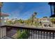 A street view from the balcony showcases well-maintained homes, lush landscaping, and mature palm trees at 7619 Belgian Lion St, Las Vegas, NV 89139