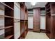 Custom walk-in closet features extensive built-in shelving, rods, and drawer storage at 7619 Belgian Lion St, Las Vegas, NV 89139