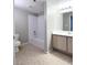 Bathroom features a shower-tub combo, a wood-look vanity, and tile-look flooring at 8101 W Flamingo Rd # 1088, Las Vegas, NV 89147