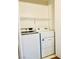 Efficient laundry space features a full-size washer and dryer and a wire rack for storage at 8101 W Flamingo Rd # 1088, Las Vegas, NV 89147