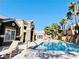 A community pool surrounded by well-maintained buildings with palm trees and lounging areas at 8101 W Flamingo Rd # 1088, Las Vegas, NV 89147