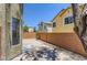 Enclosed backyard featuring low maintenance desert landscaping, mature shade tree, and a paved patio at 8143 Retriever Ave, Las Vegas, NV 89147
