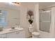 Bright bathroom featuring a shower, vanity with sink, toilet, decorative art, and indoor plant at 8143 Retriever Ave, Las Vegas, NV 89147