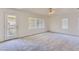 Bedroom featuring carpet, bright lighting, and a door to the exterior balcony at 8143 Retriever Ave, Las Vegas, NV 89147