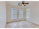 Well-lit bedroom with multiple windows, a ceiling fan and tile flooring at 8143 Retriever Ave, Las Vegas, NV 89147