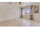 Neutral bedroom with tiled floors, ceiling fan, large windows with floral curtains at 8143 Retriever Ave, Las Vegas, NV 89147