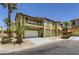 Two-story tan home with a balcony, desert landscaping and a two car garage at 8143 Retriever Ave, Las Vegas, NV 89147