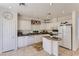Bright kitchen with white cabinets, tiled floors, granite countertops, and modern appliances at 8143 Retriever Ave, Las Vegas, NV 89147
