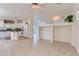 Bright living area with tile floors that transition into the kitchen area with white cabinets and breakfast bar at 8143 Retriever Ave, Las Vegas, NV 89147