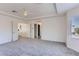Primary bedroom featuring neutral carpet, tray ceiling and several doorways at 8143 Retriever Ave, Las Vegas, NV 89147