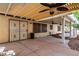 Large covered patio featuring ceiling fans and secure security doors at 9048 Faversham Ct, Las Vegas, NV 89123