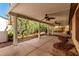 Spacious covered back patio with ceiling fans and lush landscaping at 9048 Faversham Ct, Las Vegas, NV 89123