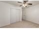 Carpeted bedroom with ceiling fan, closet, and doorway to the rest of the home at 9048 Faversham Ct, Las Vegas, NV 89123