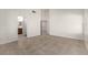 Open bedroom with wood-look flooring and a view into the attached bathroom and hallway at 9048 Faversham Ct, Las Vegas, NV 89123