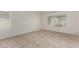 Bright bedroom with wood look tile flooring and two large windows at 9048 Faversham Ct, Las Vegas, NV 89123