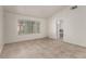 Bright bedroom featuring wood-look tile flooring and natural light from a large window at 9048 Faversham Ct, Las Vegas, NV 89123