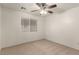 Bedroom featuring a ceiling fan, neutral carpet, and a window for natural light at 9048 Faversham Ct, Las Vegas, NV 89123