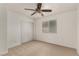 Bedroom features a ceiling fan, carpet, large window, and closet with sliding doors at 9048 Faversham Ct, Las Vegas, NV 89123