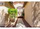 A decorative wrought-iron gate leads to the entrance of the home, surrounded by desert landscaping at 9048 Faversham Ct, Las Vegas, NV 89123