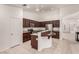 Kitchen with granite countertops, stainless steel appliances, dark cabinetry, and breakfast bar at 9048 Faversham Ct, Las Vegas, NV 89123