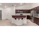 Kitchen with stainless steel appliances, dark wood cabinets, and a peninsula style breakfast bar at 9048 Faversham Ct, Las Vegas, NV 89123