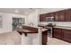 Kitchen with stainless steel appliances, breakfast bar with granite countertops, and wooden cabinetry at 9048 Faversham Ct, Las Vegas, NV 89123