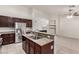 Kitchen featuring dark cabinets, stainless steel appliances, granite counters, and breakfast bar at 9048 Faversham Ct, Las Vegas, NV 89123