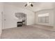 Open-concept living room featuring an electric fireplace and arched doorways at 9048 Faversham Ct, Las Vegas, NV 89123