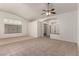 Bright living room featuring tile flooring, a ceiling fan, and arched doorways at 9048 Faversham Ct, Las Vegas, NV 89123