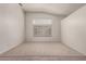 Carpeted living room with an arched window providing lots of natural light at 9048 Faversham Ct, Las Vegas, NV 89123