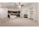 Open floorplan with living room connected to kitchen with dark cabinetry and stainless appliances at 9048 Faversham Ct, Las Vegas, NV 89123
