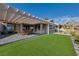 Beautiful backyard with a covered patio, artificial turf, and meticulously landscaped grounds at , Las Vegas, NV 89134