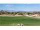 Lush backyard with a well-manicured lawn overlooking a golf course and mountain views at , Las Vegas, NV 89134
