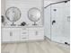 Modern bathroom with dual sinks, a walk-in shower, and neutral paint at , Las Vegas, NV 89134