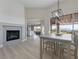 An open dining room with a modern chandelier, a fireplace, and views of the outdoors at , Las Vegas, NV 89134