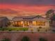 Exterior showcases the beautifully landscaped backyard with sunset views, covered patio, and desert landscaping at , Las Vegas, NV 89134