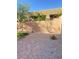 Stone-paved backyard with gravel and a patch of green grass, perfect for low-maintenance outdoor living at 10349 Mystic Pine Rd, Las Vegas, NV 89135
