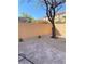 This backyard features stone pavers, gravel landscaping, and a mature tree, creating a relaxing outdoor area at 10349 Mystic Pine Rd, Las Vegas, NV 89135