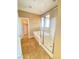 Bathroom featuring a tub-shower combo with a glass door and a view to a walk-in closet at 10349 Mystic Pine Rd, Las Vegas, NV 89135