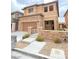 Charming two-story home featuring a stone facade, neutral stucco, and a well-maintained front yard at 10349 Mystic Pine Rd, Las Vegas, NV 89135